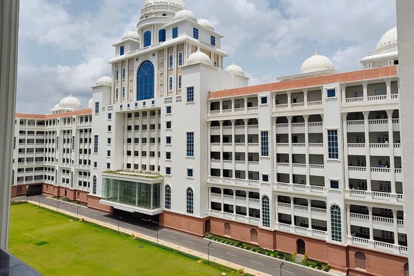 The white, domed Dr. B.R. Ambedkar Telangana State Secretariat in Hyderabad, seen from an upper floor across a lawn