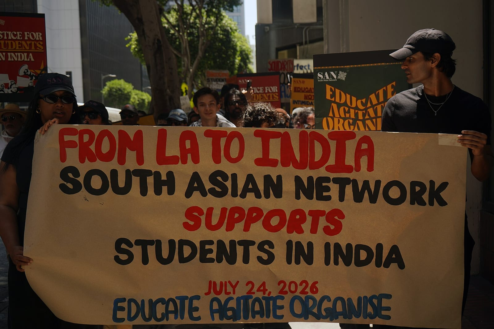 Marchers in Los Angeles hold a banner reading 'From LA to India, South Asian Network supports students in India, July 24, 2026, Educate Agitate Organise'