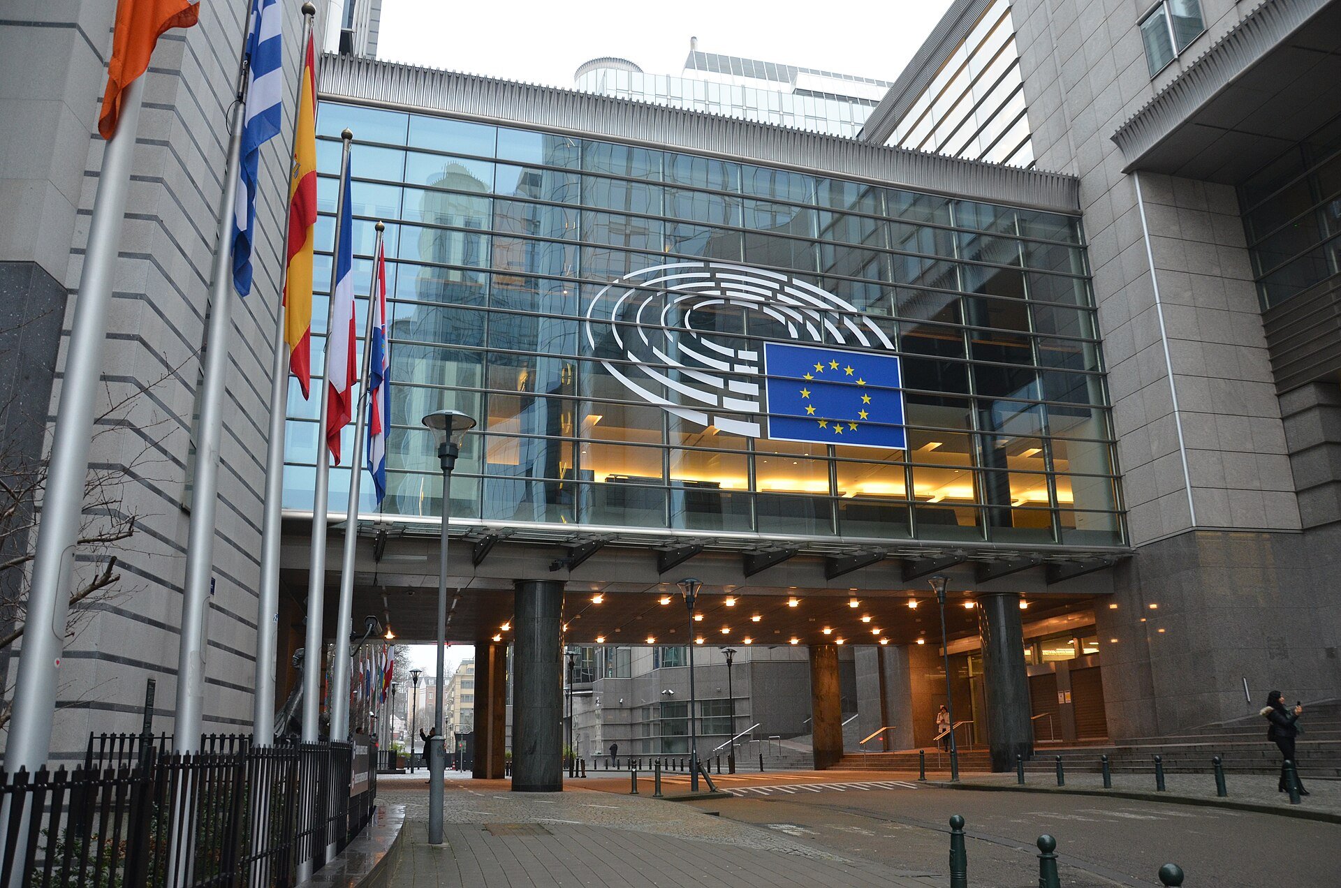 The European Parliament building in Brussels, with the EU flag and Parliament logo above its glass entrance