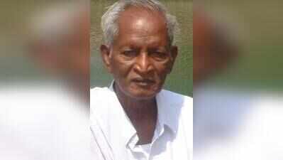 A. Raju, an elderly man with white hair in a white shirt